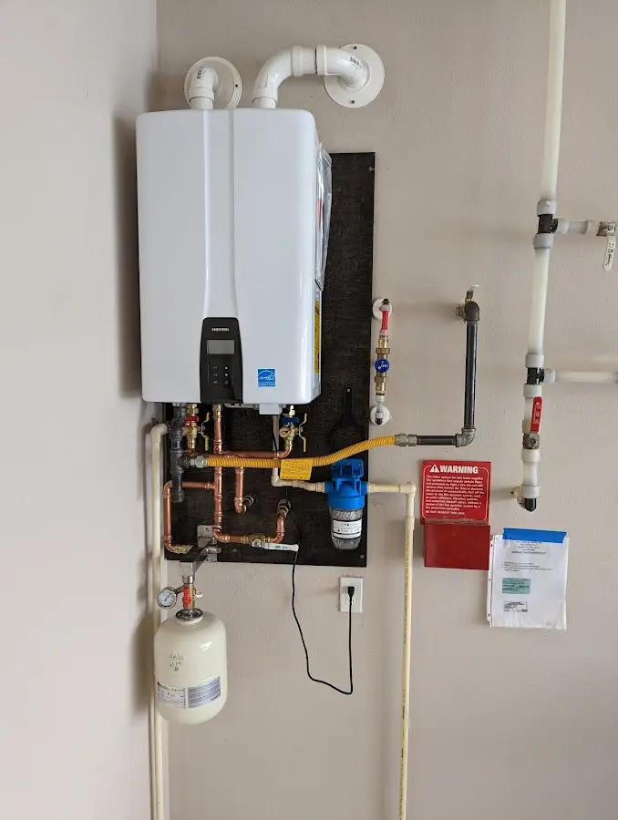 Professional plumber installing copper piping in a North Haven home